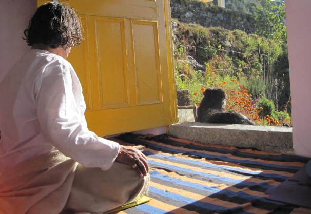 Shivam Meditating in the sun with Dog on Threshold